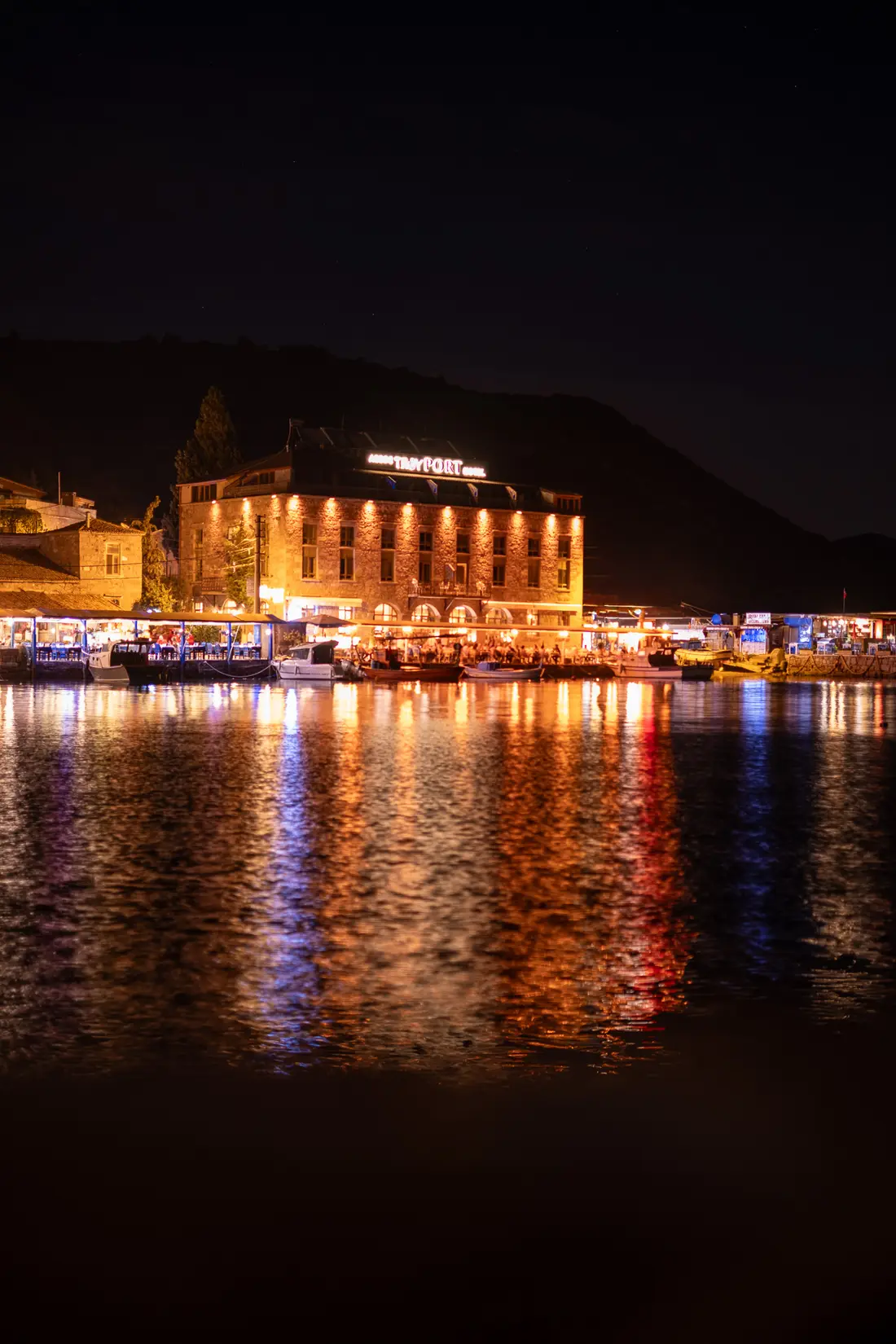 The Ancient Harbour of Assos at night, Troy Port Hotel lights reflected on the sea